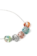 Colorful SALVÁREA Soplo multiple necklace with layered chains and vibrant beads, stylish accessory for casual or chic outfits.