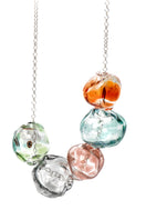 Colorful SALVÁREA Soplo multiple necklace featuring layered chains with vibrant beads and charms for a stylish look.