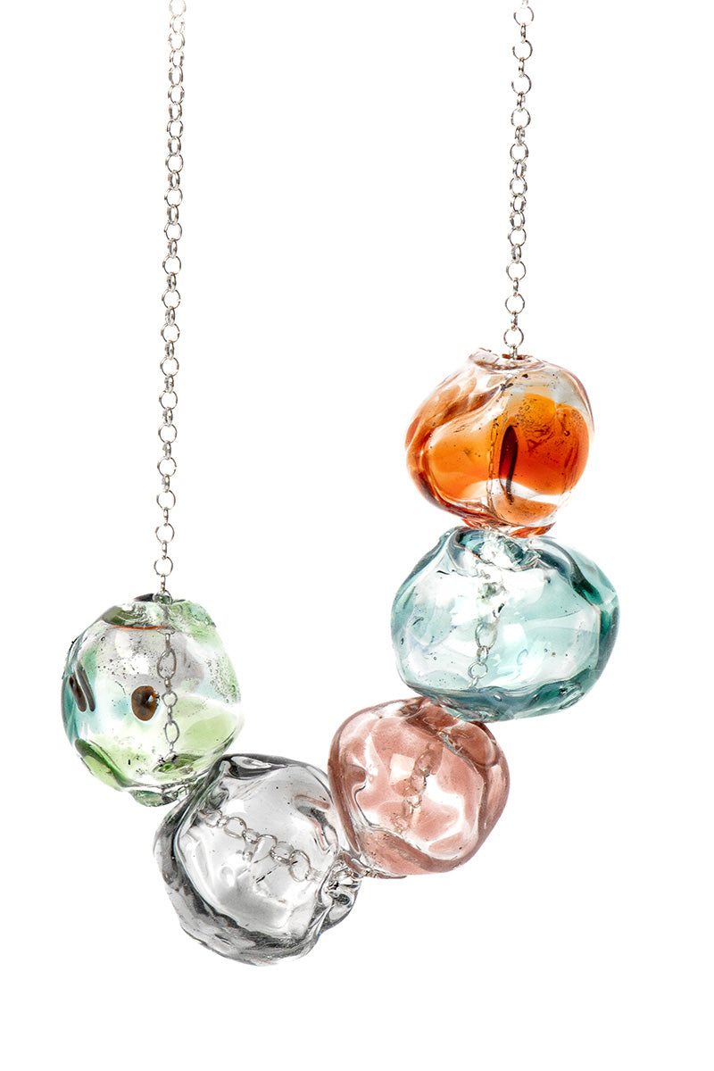 Colorful SALVÁREA Soplo multiple necklace featuring layered chains with vibrant beads and charms for a stylish look.