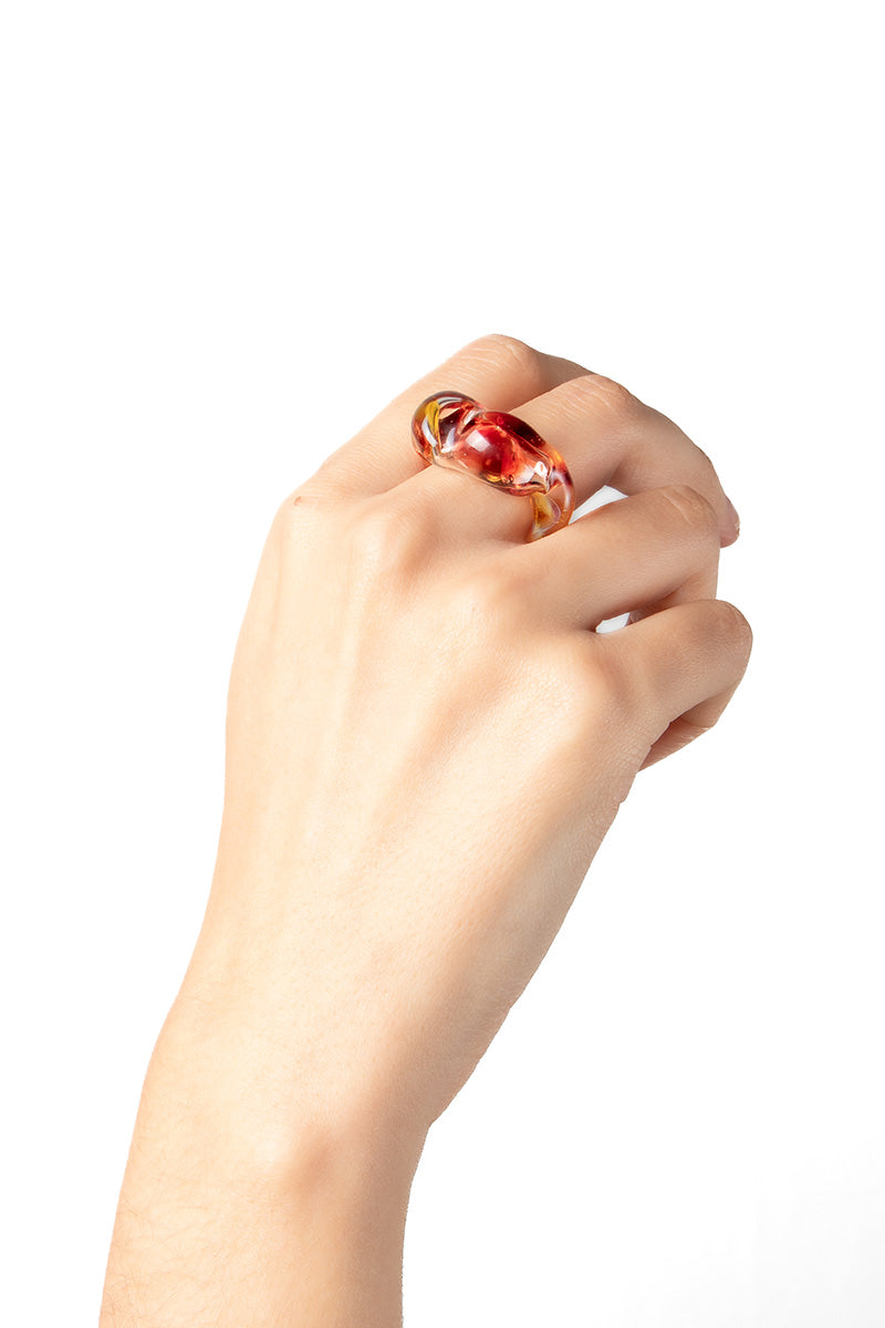 Salvarea Soplo Ring Set with vibrant red rings featuring intricate design, stacked and displayed on a neutral background.