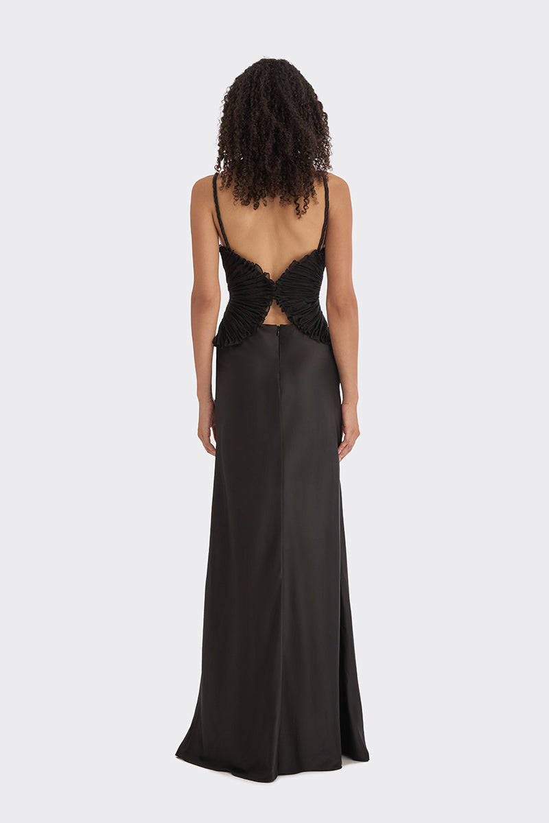 Black spiral lotus leaf maxi dress by Stolen Stores, flowing fabric with a spiral leaf pattern, styled for elegant wear.