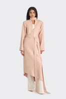 Dusty pink spiral wrap coat by Stolen Stores, shown on a model with a stylish, layered design and cozy fabric.