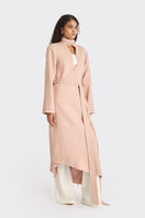 Dusty pink spiral wrap coat by Stolen Stores, featuring a stylish, cozy design with a unique spiral pattern and soft fabric.