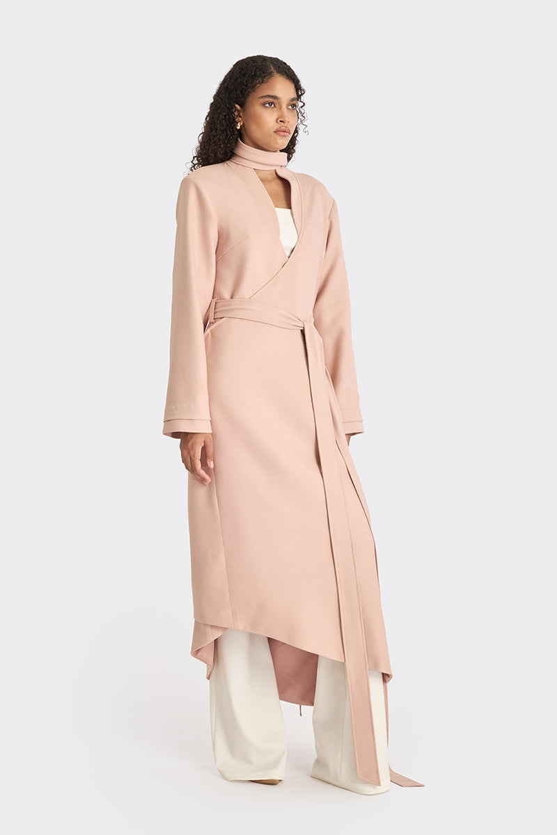 Dusty pink spiral wrap coat by Stolen Stores, featuring a stylish, cozy design with a unique spiral pattern and soft fabric.