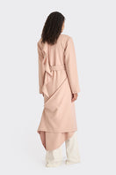 Dusty pink spiral wrap coat by Stolen Stores, shown on a model, featuring a stylish, cozy design perfect for cooler weather.