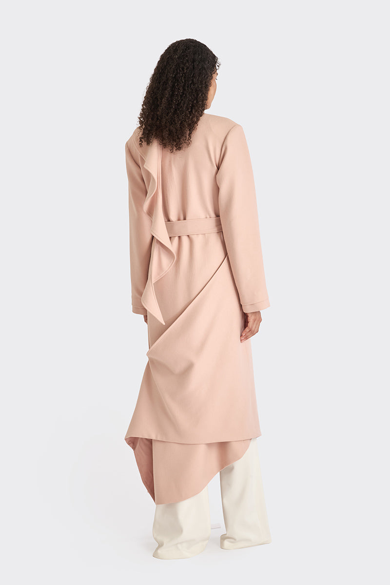 Dusty pink spiral wrap coat by Stolen Stores, shown on a model, featuring a stylish, cozy design perfect for cooler weather.