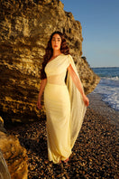 Rayane Bacha Stellamaris Dress in butter yellow, elegant gown with flowing fabric and detailed neckline, perfect for formal occasions.