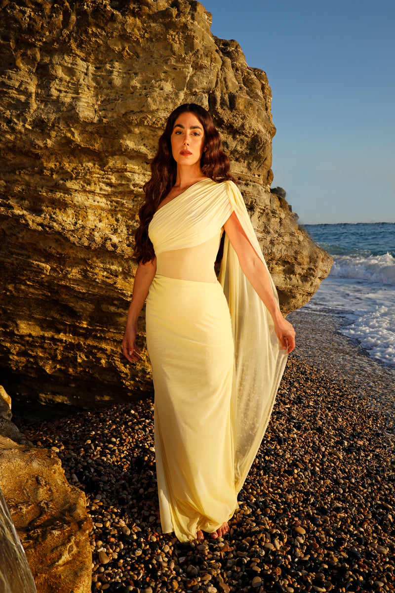 Rayane Bacha Stellamaris Dress in butter yellow, elegant gown with flowing fabric and detailed neckline, perfect for formal occasions.