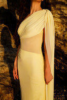 Rayane Bacha Stellamaris gown in butter yellow, elegant floor-length dress with flowing fabric and intricate details.