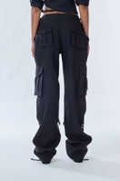Black cargo pants from Stolen Stores featuring multiple pockets and a relaxed fit, displayed on a neutral background.