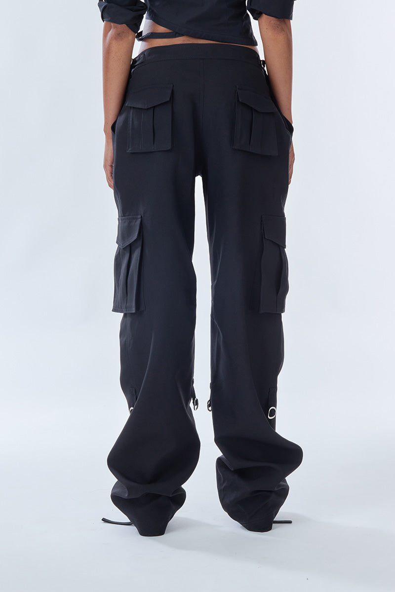 Black cargo pants from Stolen Stores featuring multiple pockets and a relaxed fit, displayed on a neutral background.