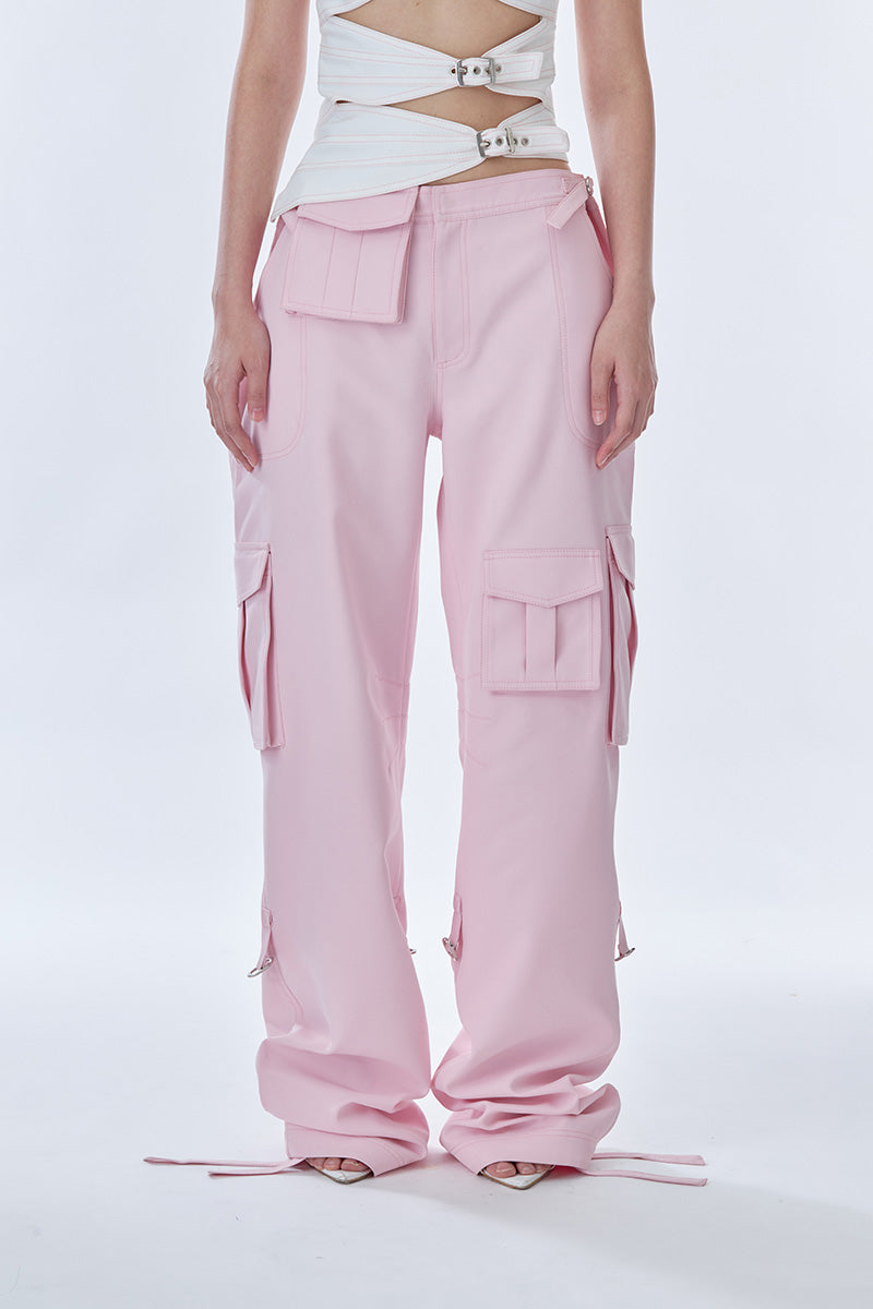 Pink cargo pants by Stolen Stores with multiple pockets, laid flat to showcase their casual, stylish design.