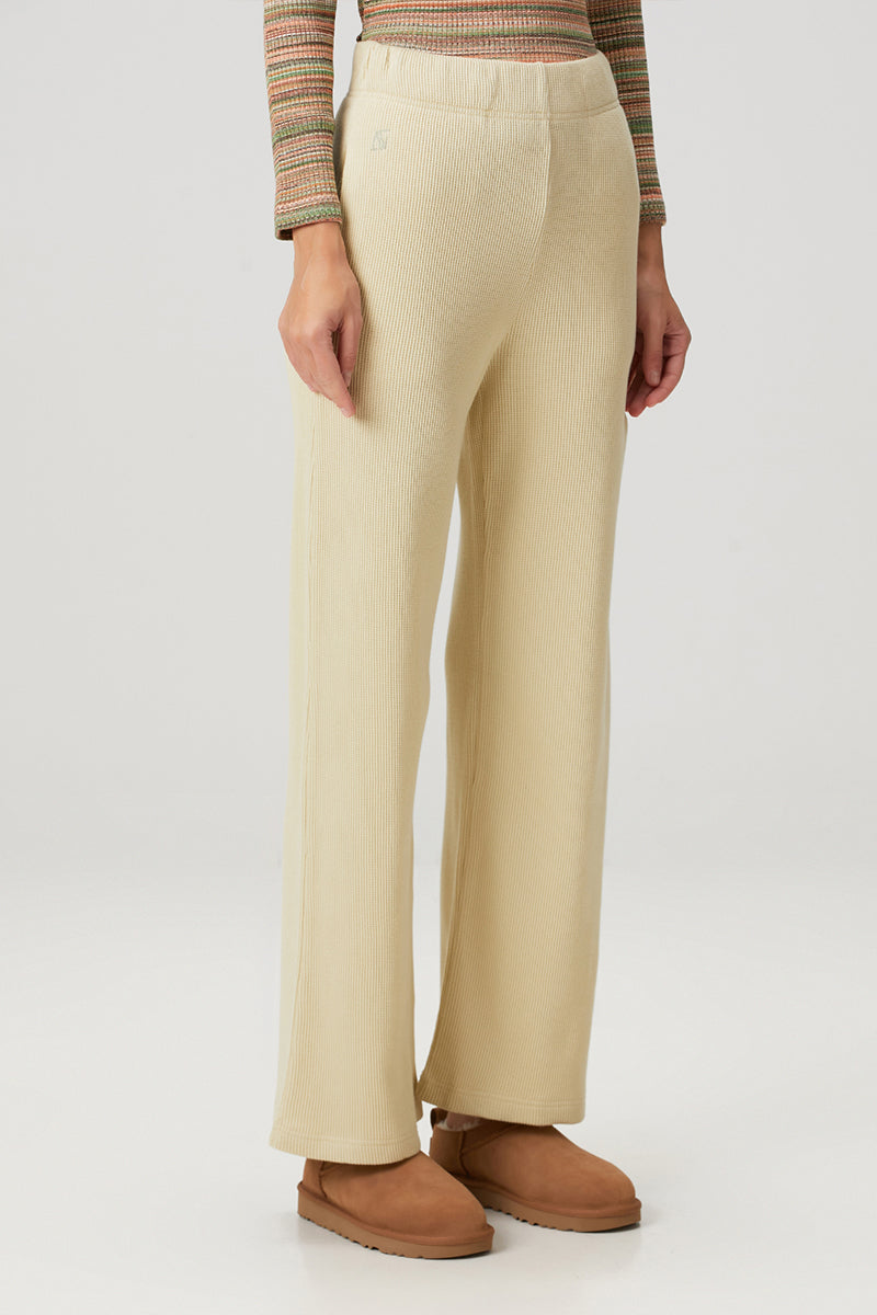 Yellow Bassigue straight leg sweatpants displayed on a hanger, showcasing comfortable casual pants for everyday wear.