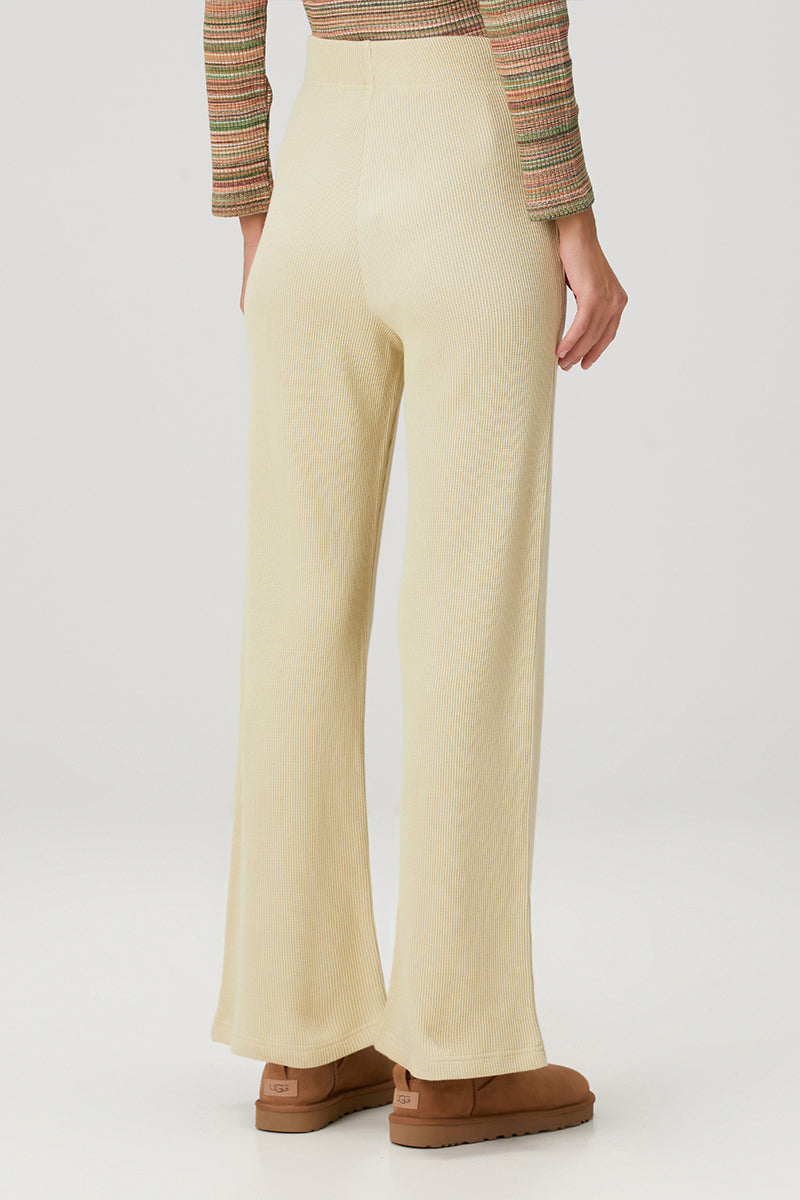 Yellow Bassigue straight leg sweatpants laid flat, showcasing the relaxed fit and soft fabric.