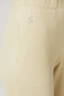 Bright yellow Bassigue straight-leg sweatpants lying flat on a white surface, showcasing the relaxed fit and soft fabric.