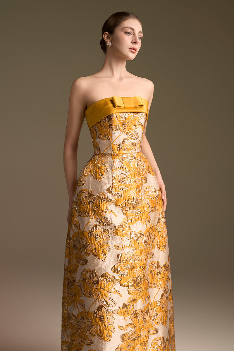 Yellow jacquard strapless ballgown by I.H.F with draped bow detail in agate silk, designed for elegant occasions.