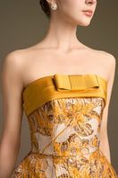 I.H.F Cult Mia X strapless yellow jacquard ballgown with draped bow detail in agate silk fabric.