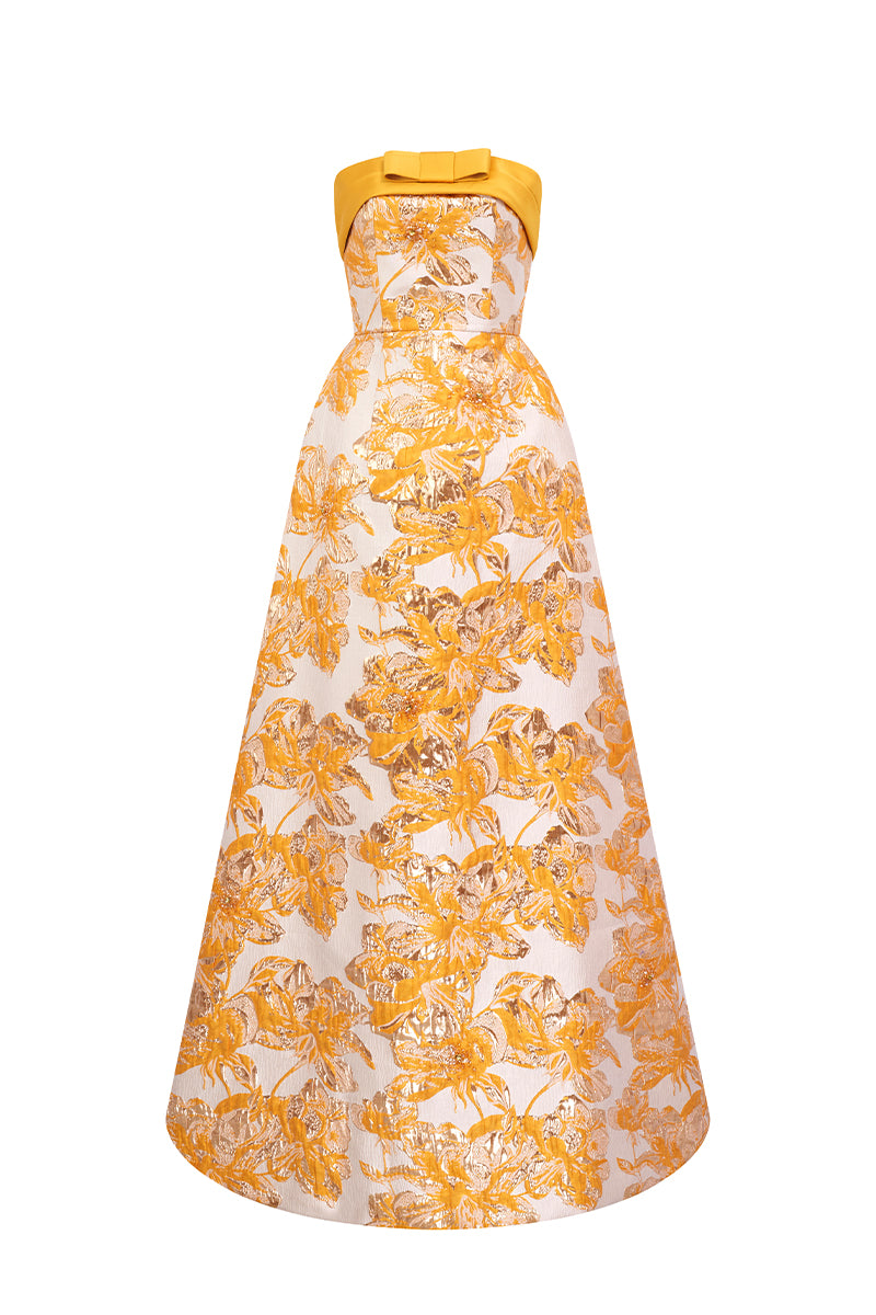 Yellow jacquard ballgown by I.H.F with strapless design, draped bow detail, and luxurious agate silk fabric.