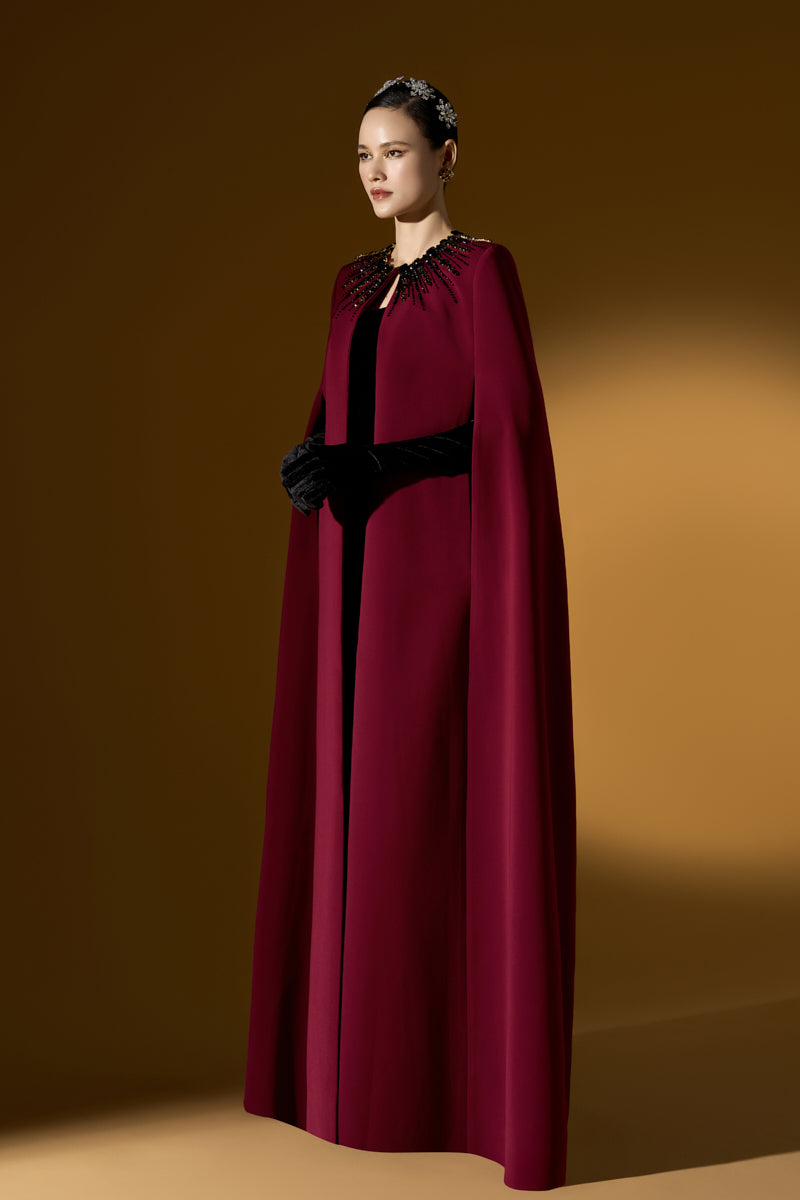 I.H.F ruby crepe and Lyon velvet strapless gown with a bustier top and long cape for elegant evening wear.
