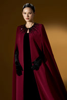 I.H.F ruby crepe and Lyon velvet strapless gown with a bustier design and long cape for elegant evening wear.