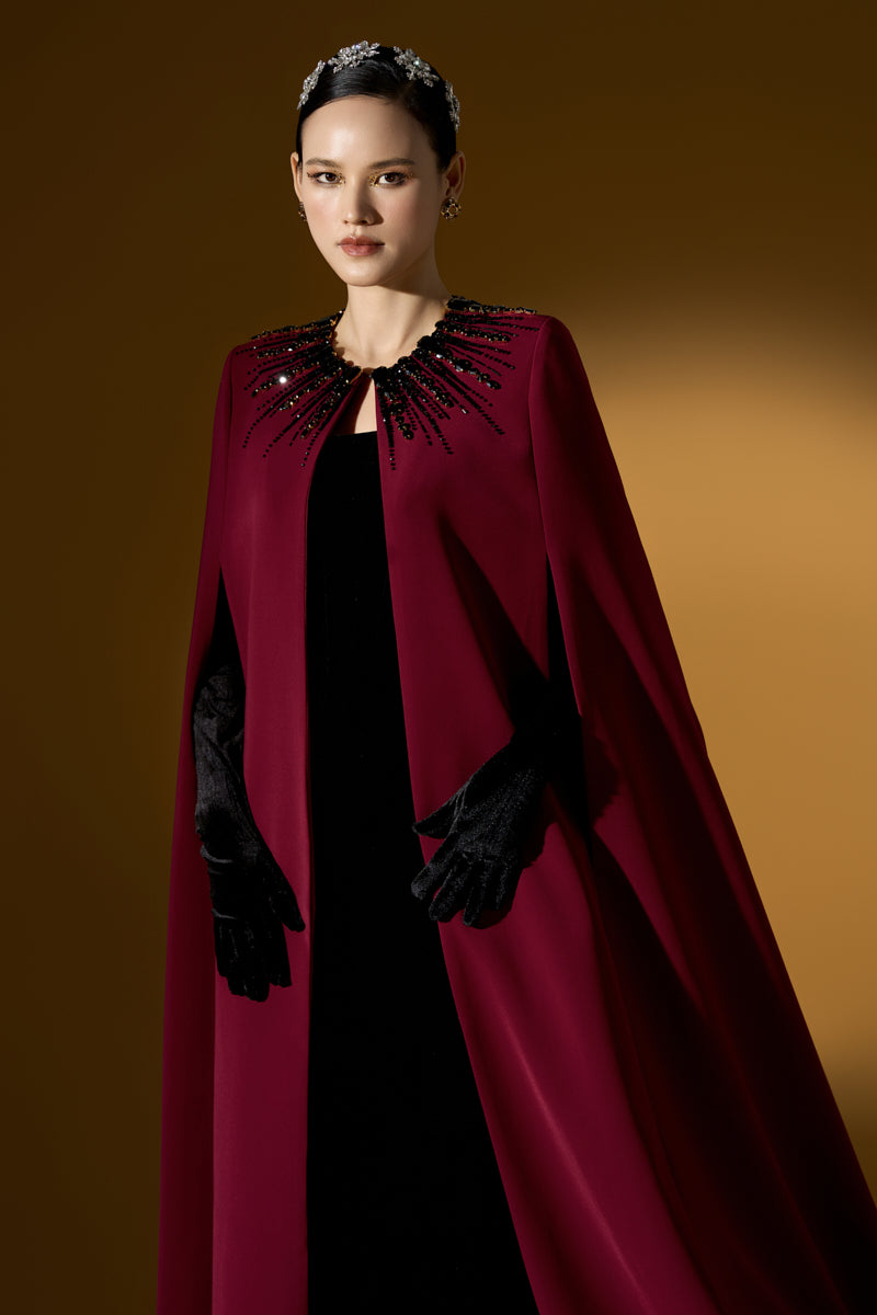 I.H.F ruby crepe and Lyon velvet strapless gown with a bustier design and long cape for elegant evening wear.