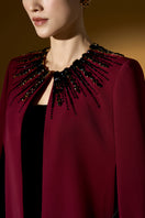 Strapless ruby crepe and lyon velvet gown by I.H.F featuring a bustier style, column silhouette, and long cape.