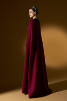 Elegant strapless ruby crepe and Lyon velvet gown by I.H.F featuring a bustier-style bodice, column silhouette, and long cape.