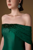 Green I.H.F taffeta silk-lined gown with strapless bustier and draped off-shoulder details, elegant column silhouette