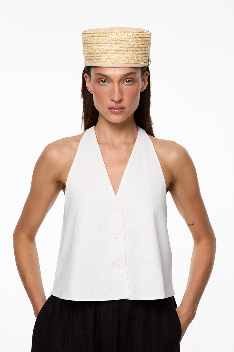 Le Sh Ka straw pillbox hat with a sleek, structured design and a narrow brim, perfect for stylish summer outfits.
