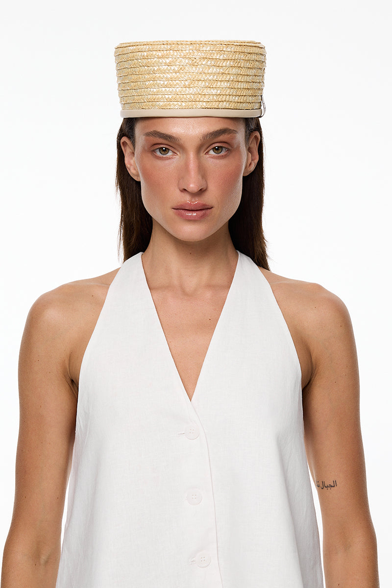 Light beige straw pillbox hat by LE SH KA, featuring a classic, structured design with a narrow brim and elegant style.