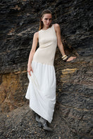 Nelblu beige maxi dress with flowing fabric and sleeveless design, stylishly draped on a hanger.