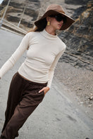 Nelblu KAIA beige top, stylish women’s blouse with soft fabric and relaxed fit, shown in a close-up front view.