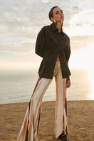 Nelblu Jagger Print Orange Cover Up pants with vibrant pattern, lightweight fabric, stylish design, perfect for beach or poolside wear.