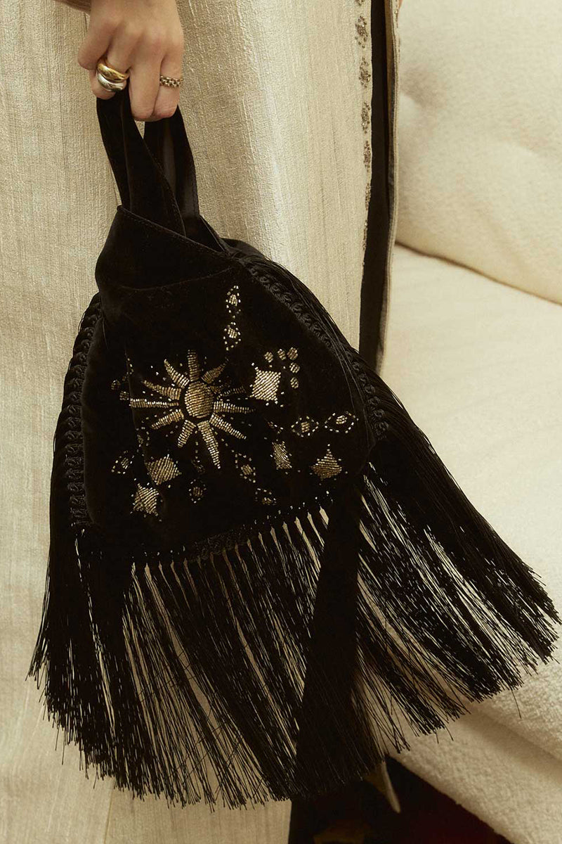 Sarah's Bag black velvet slip bag with fringes, top handle design featuring a sunrise pattern on the front.