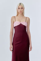 Stolen Stores Swan Slip Maxi Dress in burgundy with pink accents, featuring a flowing design and sleeveless style.