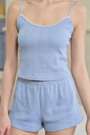 Woman wearing a cream knit camisole from MANITO, styled as a casual women's top with a soft, cozy fabric.