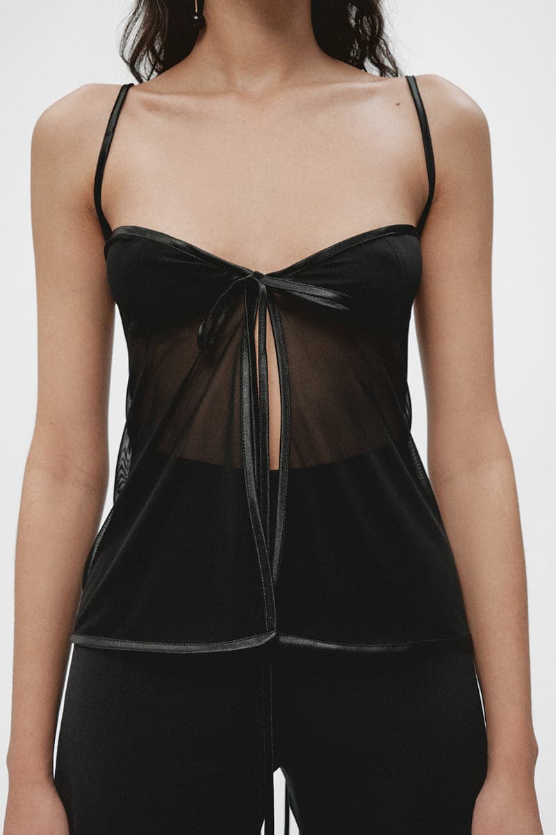Black lingerie top by JC Pajares, stylish and feminine, with lace details and adjustable straps, shown on a model.