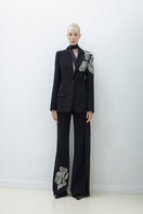 Hand embroidered pants by TAGG featuring intricate embroidery and comfortable fit, shown in a natural stance.