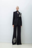 Hand embroidered pants by TAGG featuring intricate embroidery and comfortable fit, shown on a model.