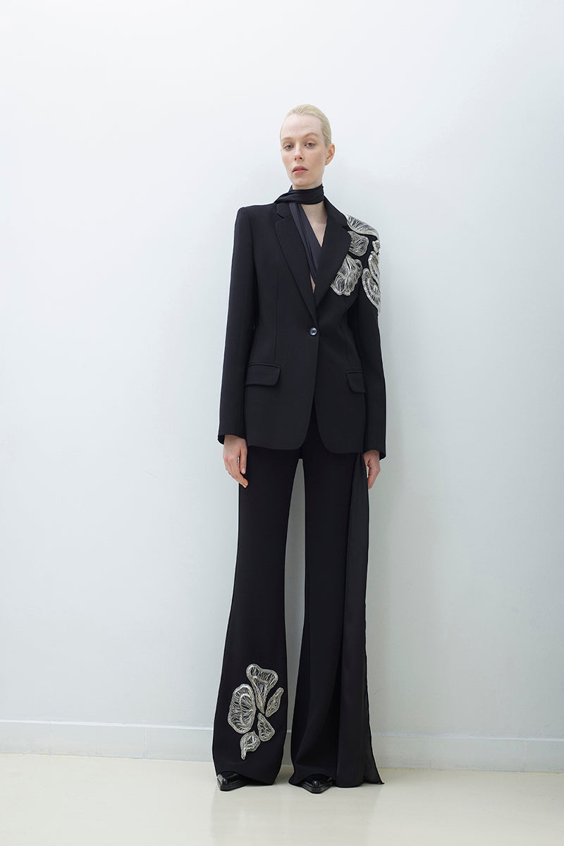 Hand embroidered pants by TAGG featuring intricate embroidery and comfortable fit, shown on a model.
