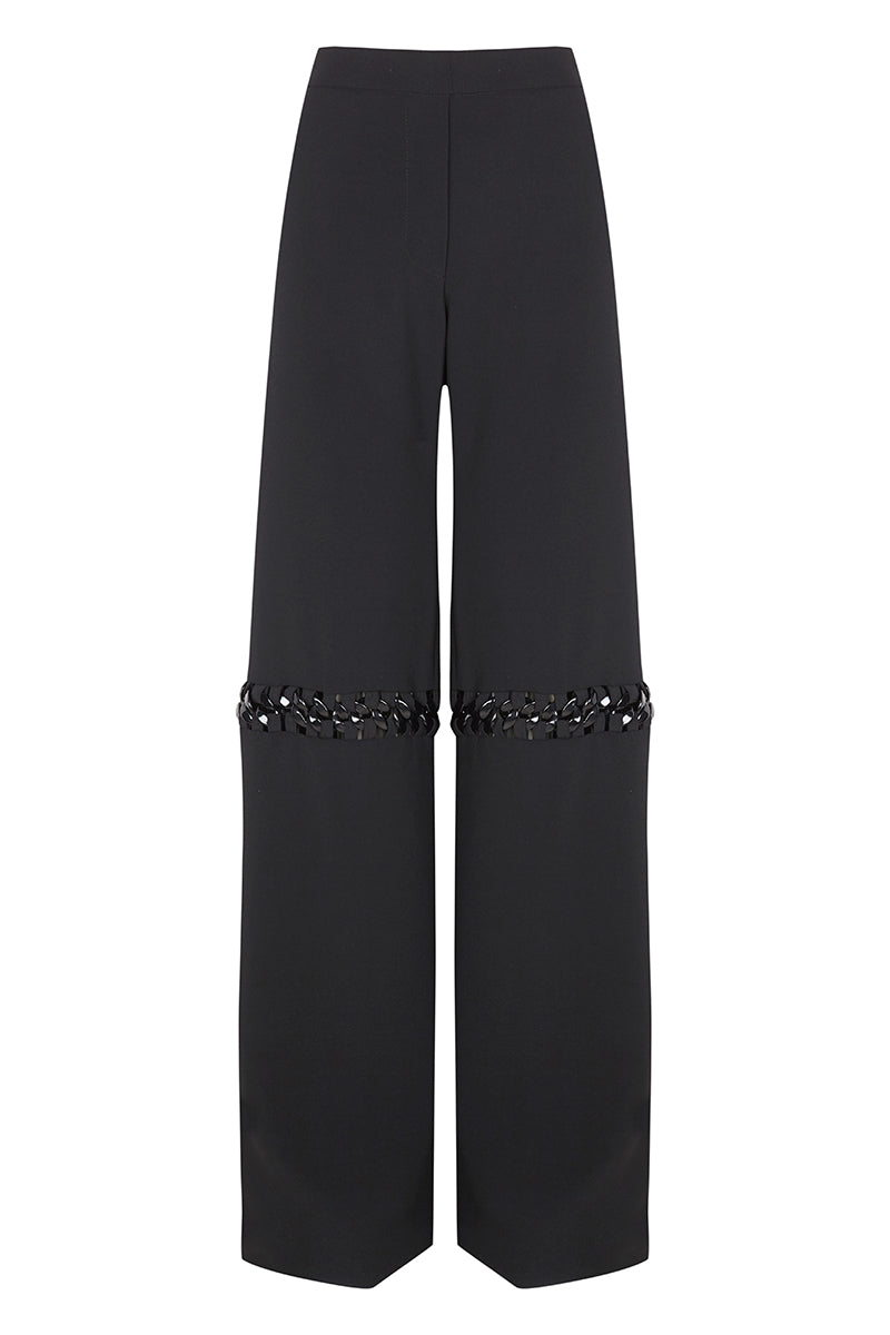 Pair of JC Pajares pants with metal chain accents, featuring a stylish and trendy design with a relaxed fit and detailed stitching.