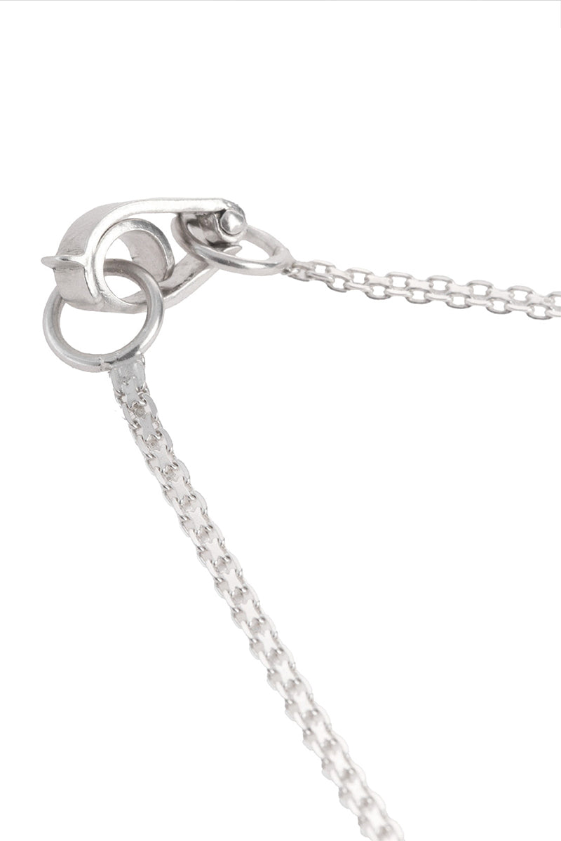 Close-up of MAZ Manuela Álvarez thick glass choker necklace showcasing its bold, clear glass design on a neutral background.