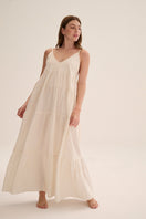 Nelblu Tiempors ecru maxi dress with a flowing silhouette and elegant design, perfect for casual or dressy occasions.