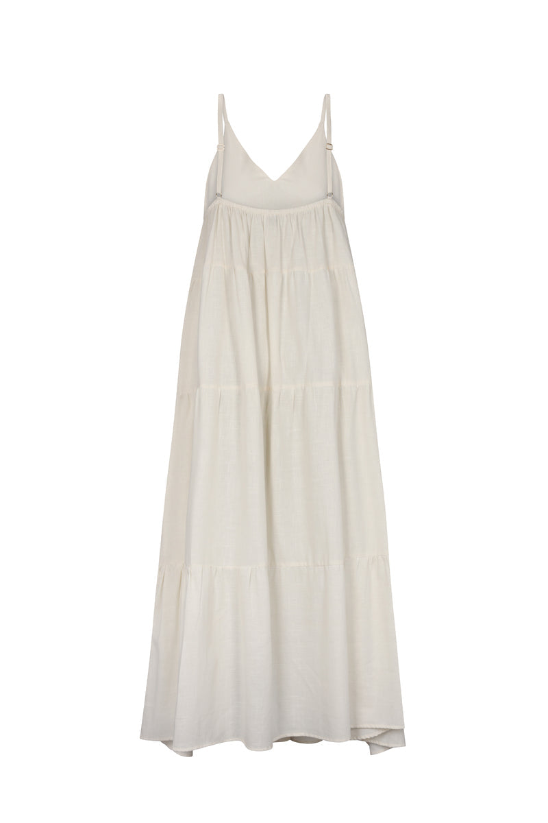 Beige Nelblu Tiempos maxi dress with flowing fabric and elegant design, shown from the back.