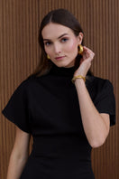 Black structured midi dress by UNDRESS featuring a fitted waist and sleek design, perfect for stylish occasions.