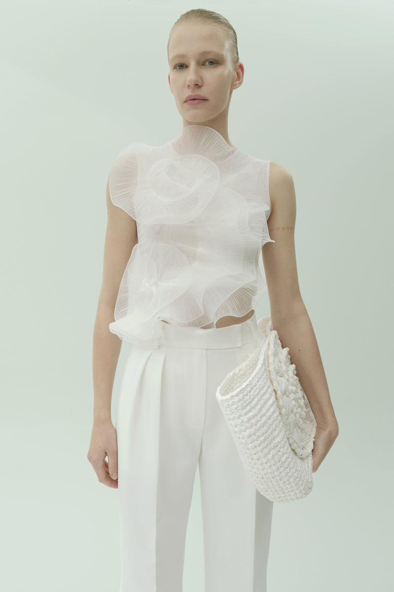 White translucent flower blouse with pleated decor by Nadya Dzyak, featuring delicate floral details and lightweight fabric.