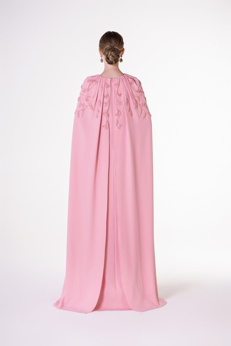 Pink velvet satin cape dress by Tracy Studio, elegant maxi dress with flowing fabric and luxurious texture.