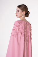Pink velvet satin cape gown by Tracy Studio, featuring elegant draping and luxurious fabric for formal occasions.