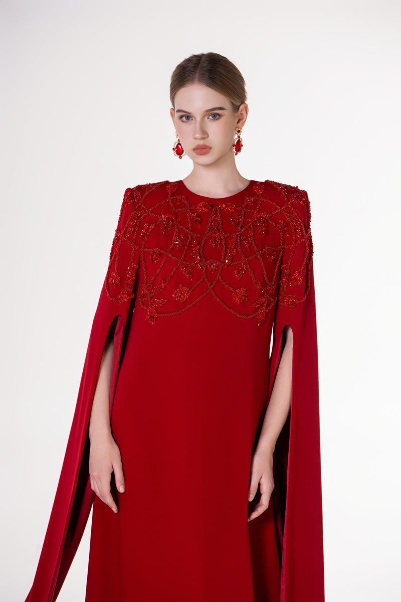 Red velvet satin maxi dress with round neckline by Tracy Studio, showcased with flowing fabric and elegant design.