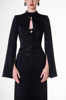 Black velvet satin floor-length gown by Tracy Studio, elegant evening dress with a flowing silhouette and luxurious fabric.